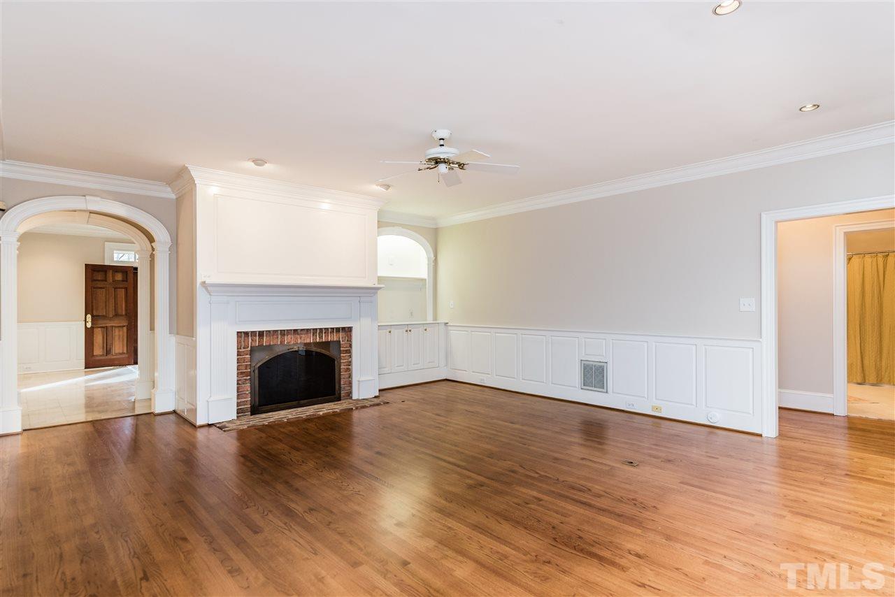 3103 Landor Road Raleigh, NC 27609 - Photo 7 of 25 a view of empty room with wooden floor and fireplace