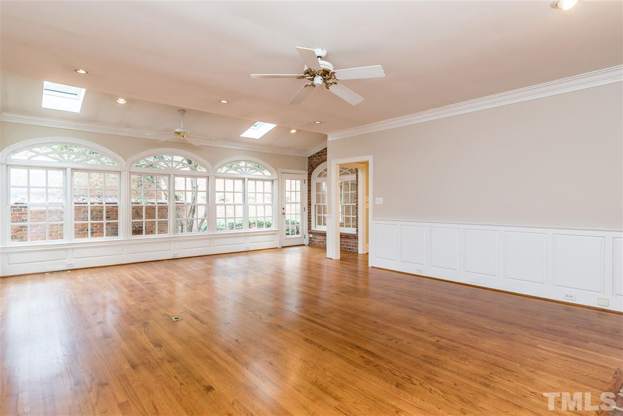 3103 Landor Road Raleigh, NC 27609 - Photo 8 of 25 a view of an empty room with a window and wooden floor