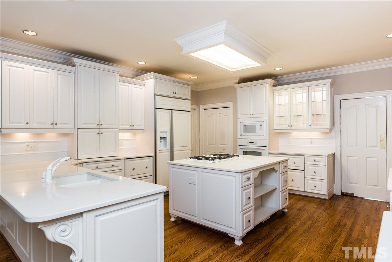 3103 Landor Road Raleigh, NC 27609 - Photo 10 of 25 a kitchen with a stove a sink and a refrigerator