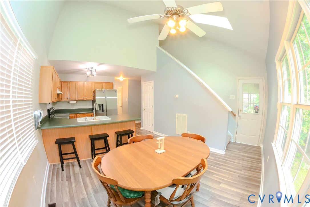 9424 Lockberry Ridge Loop Richmond, VA 23237 - Photo 16 of 24 Vaulted ceiling with a ceiling fan, wood-finish fl