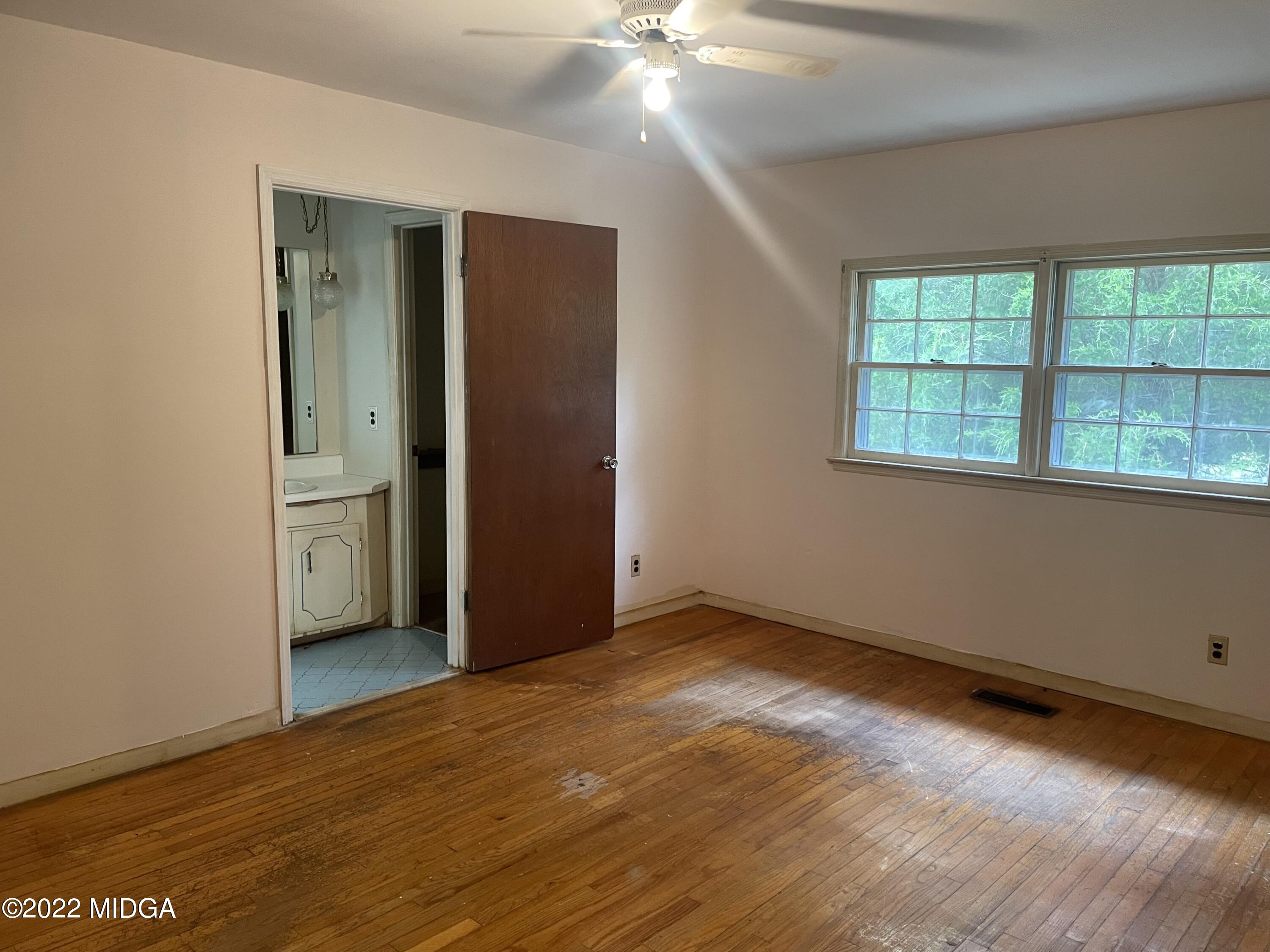 304 Old Benton Road Juliette, GA 31046 - Photo 8 of 17 an empty room with wooden floor and windows