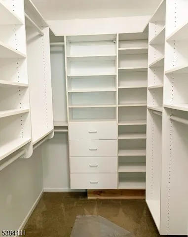 a view of walk in closet with empty racks
