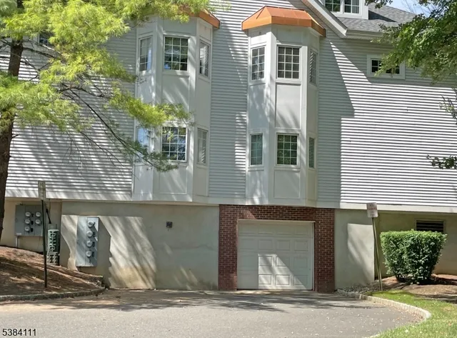 a front view of a house with garage