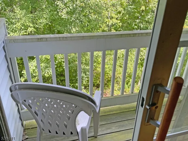 a view of a two chairs in the balcony