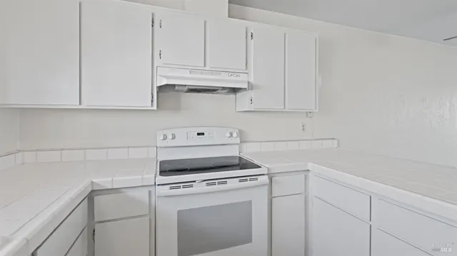 a view of cabinets and washer dryer
