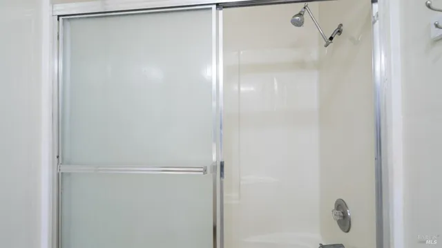 a bathroom with a glass shower door