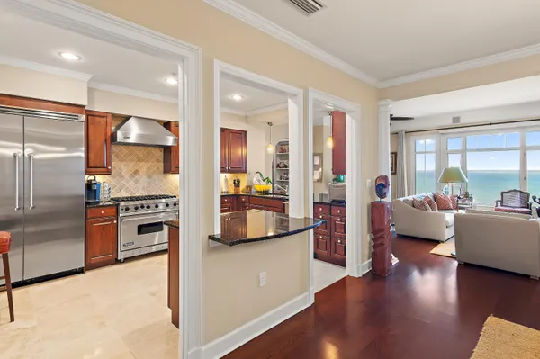 a kitchen with stainless steel appliances granite countertop a stove a sink and a refrigerator