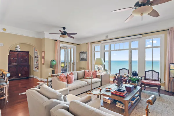 a living room with furniture a ceiling fan and a window