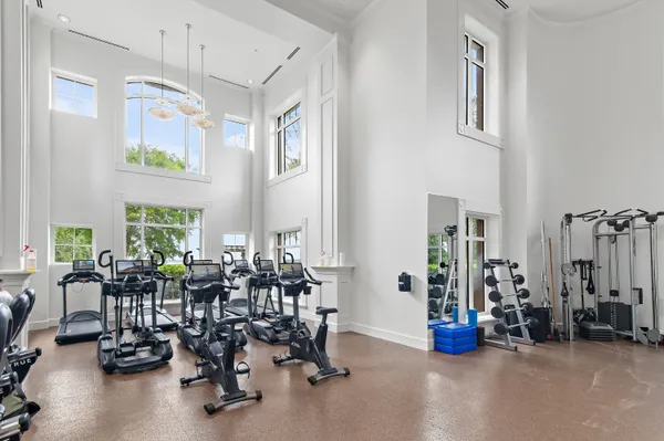 a large dining hall with stainless steel appliances kitchen island granite countertop a table and chairs