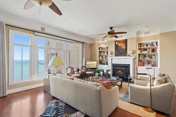 a living room with furniture a fireplace and a chandelier