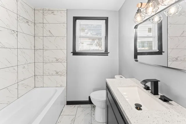 a bathroom with a sink a toilet and bathtub