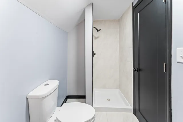 a white toilet sitting next to a bathroom sink