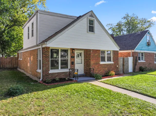 a front view of a house with a yard and porch