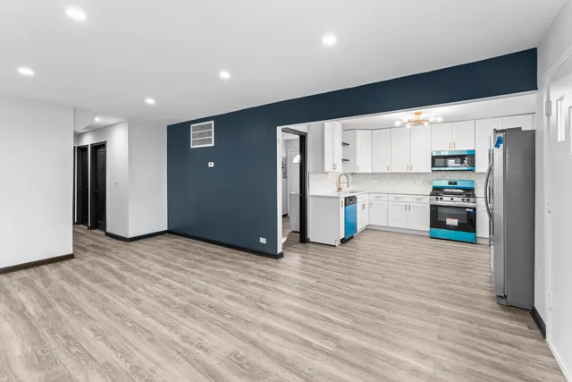 a view of kitchen with stainless steel appliances refrigerator oven microwave and stove