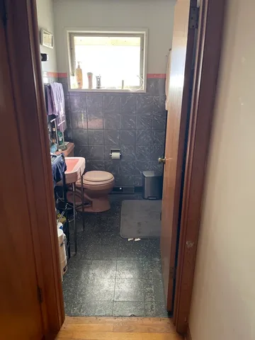 a bathroom with a toilet and a shower