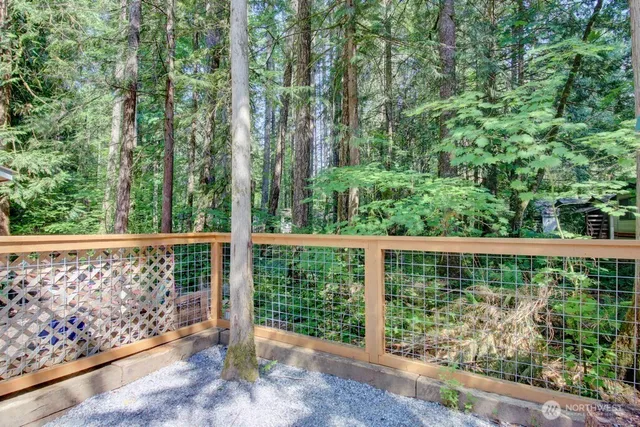 a view of a chair and table in the backyard