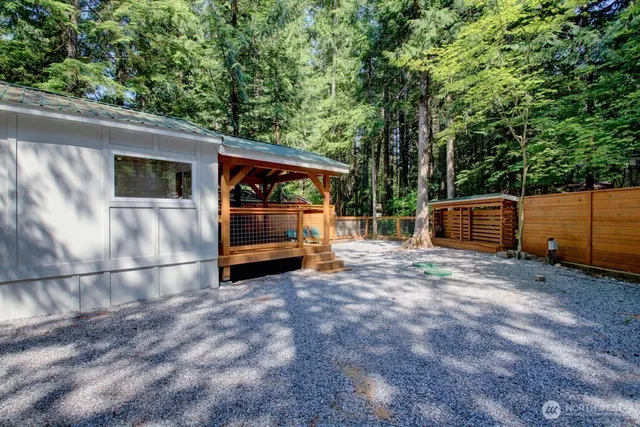 a backyard of a house with a barbeque oven and outdoor seating