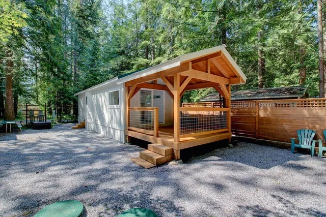 a view of a balcony with floor to ceiling window next to a yard