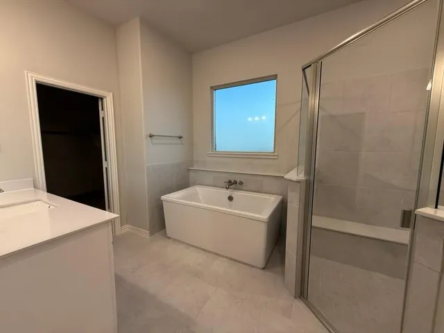 a bathroom with a bathtub a sink and a shower