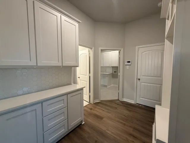 a view of cabinets and wooden floor