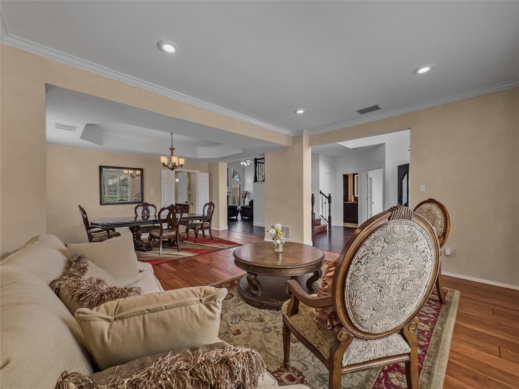 2317 Wellesly Road Rowlett, TX 75089 - Photo 8 of 39 a living room with furniture a dining table and wooden floor