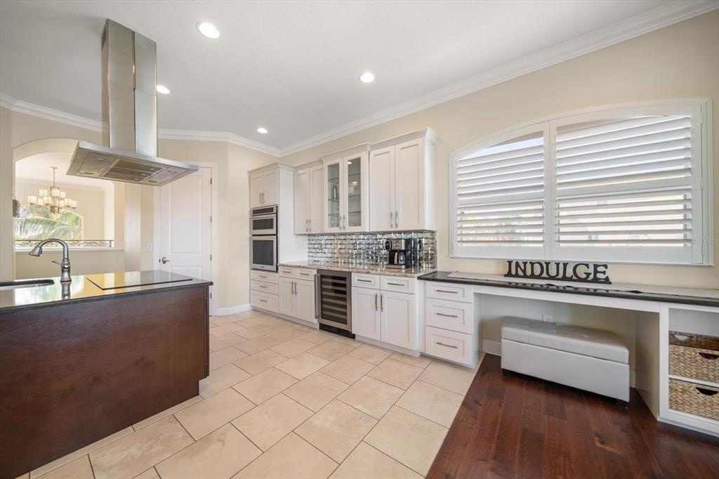 478 Harbor Drive South Indian Rocks Beach, FL 33785 - Photo 22 of 73 a kitchen with stainless steel appliances granite countertop a stove a sink and white cabinets