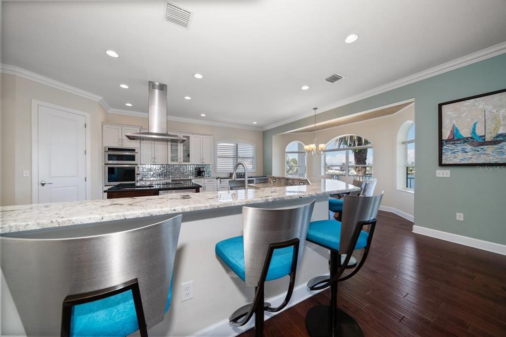 478 Harbor Drive South Indian Rocks Beach, FL 33785 - Photo 27 of 73 a kitchen with stainless steel appliances granite countertop a dining table chairs and sink