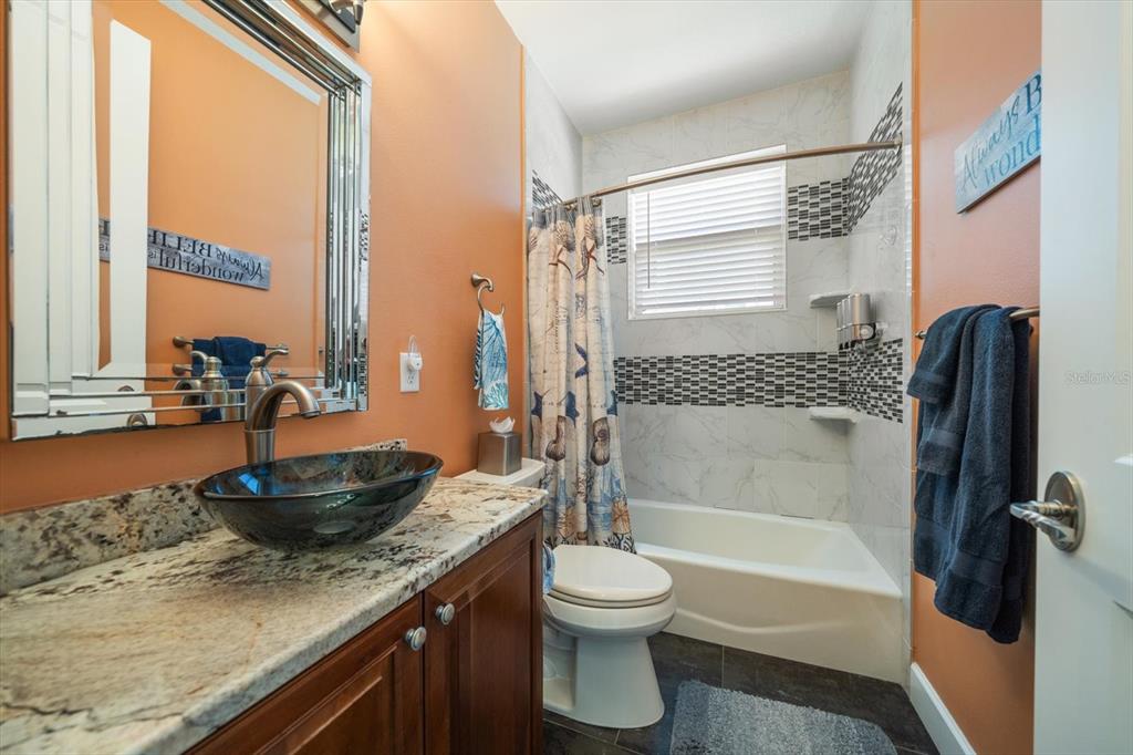 478 Harbor Drive South Indian Rocks Beach, FL 33785 - Photo 46 of 73 a bathroom with a granite countertop sink toilet and shower