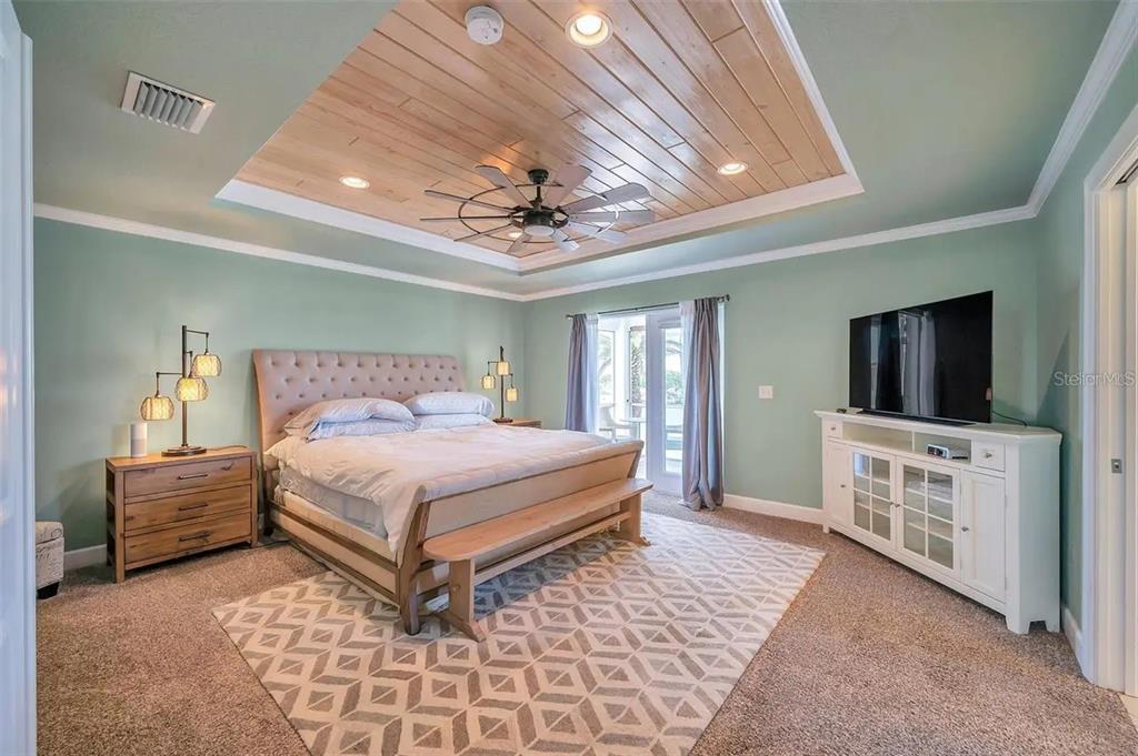 478 Harbor Drive South Indian Rocks Beach, FL 33785 - Photo 9 of 73 a bedroom with a large bed and a flat screen tv