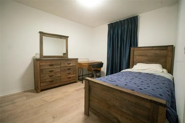 a bedroom with a bed and a dresser