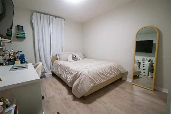 a bedroom with a bed and a television