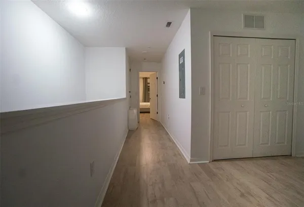 a view of a hallway with wooden floor