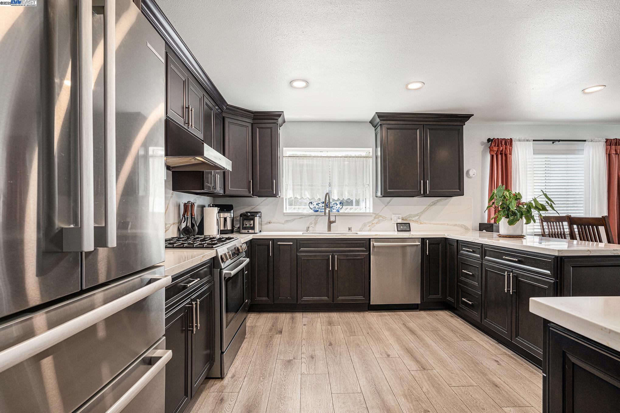 111 Overacker Terrace Fremont, CA 94536 - Photo 13 of 33 a kitchen with stainless steel appliances granite countertop a sink stove and refrigerator