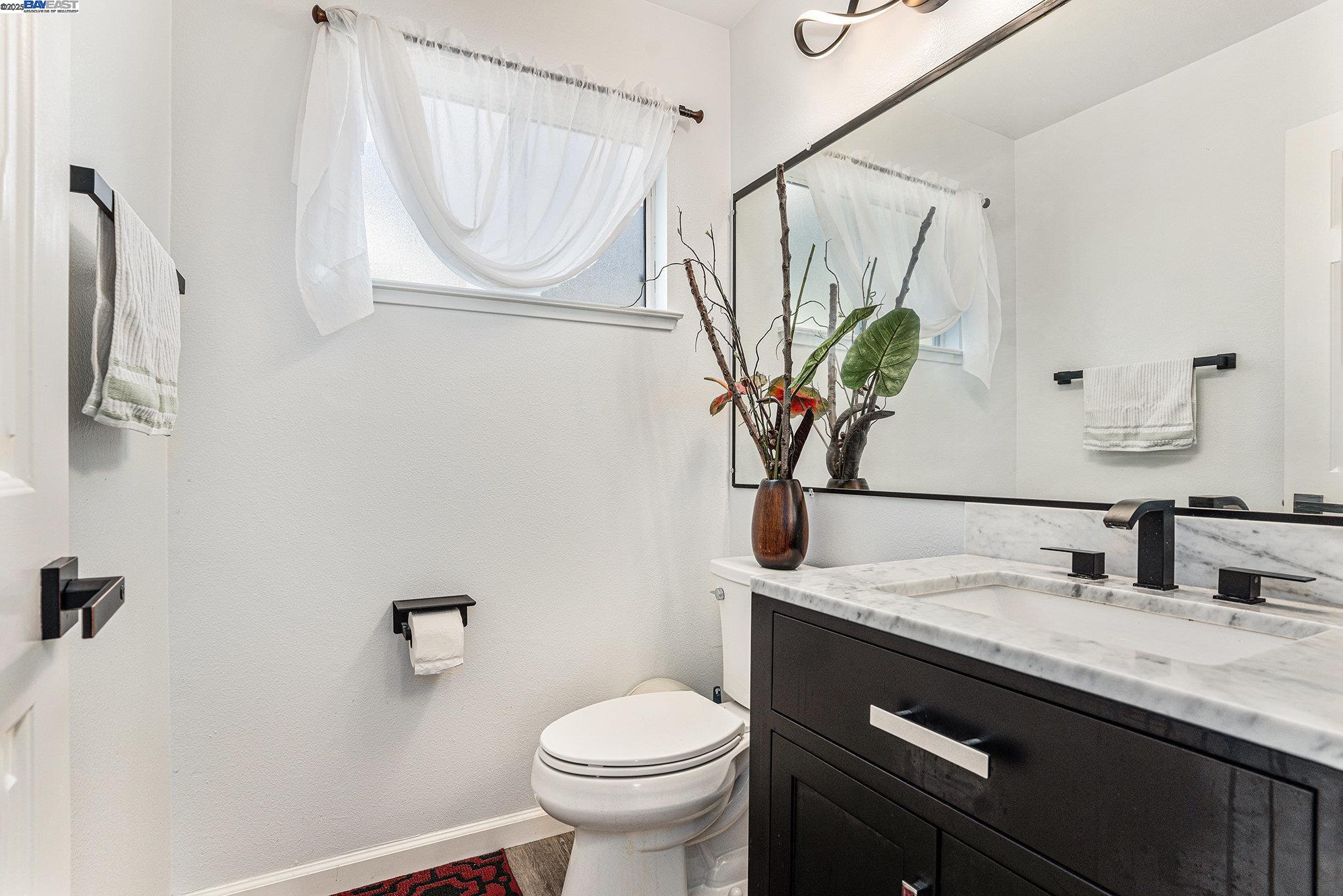 111 Overacker Terrace Fremont, CA 94536 - Photo 15 of 33 a bathroom with a granite countertop sink a toilet and a mirror