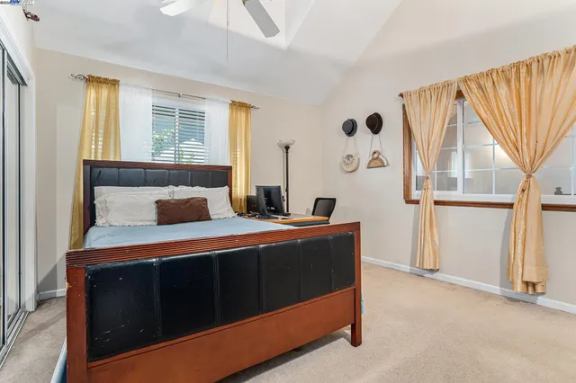 a bed sitting in a bedroom next to a window