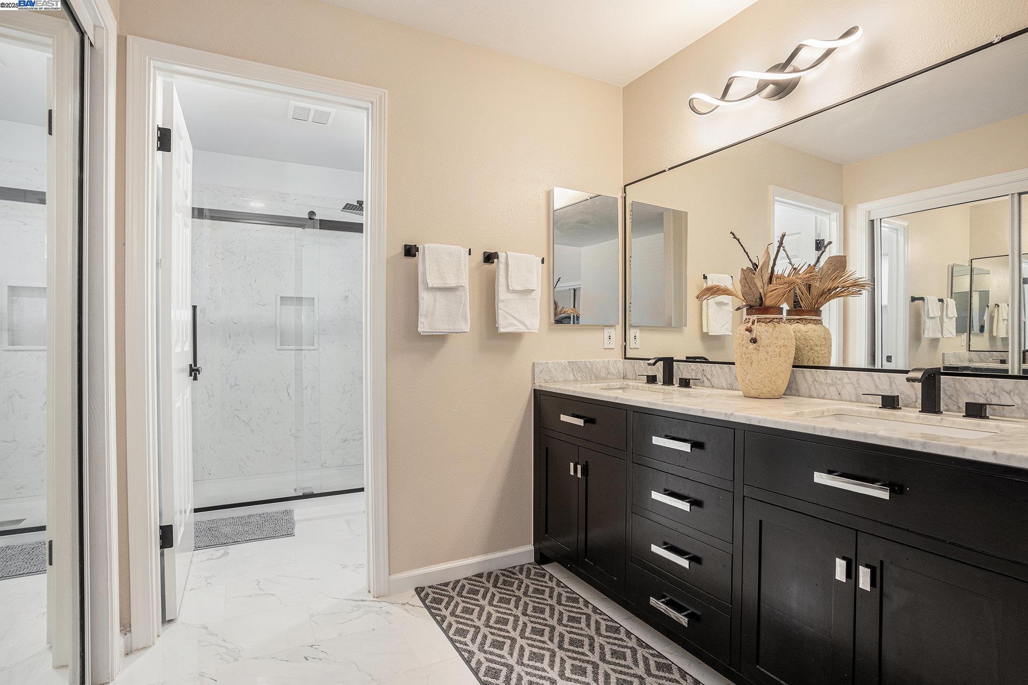 111 Overacker Terrace Fremont, CA 94536 - Photo 24 of 33 a bathroom with a double vanity sink a mirror and a shower