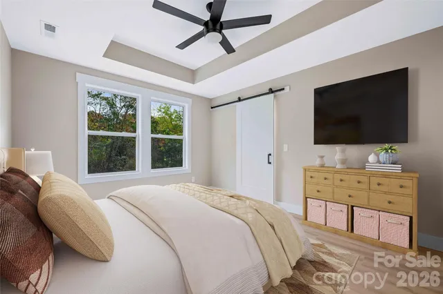 a bedroom with a bed and a flat screen tv