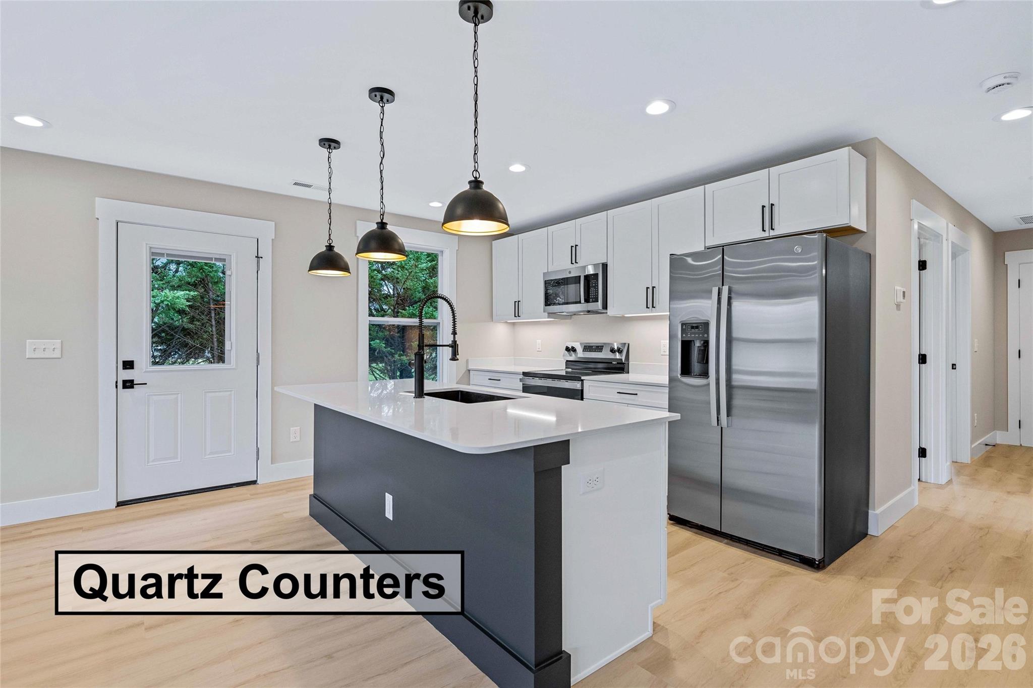 14 Knox Road Black Mountain, NC 28711 - Photo 21 of 44 a kitchen with kitchen island a counter a refrigerator a sink a stove and a window
