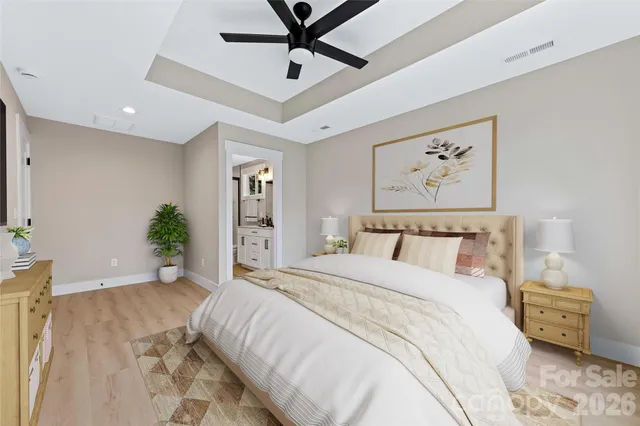 a bedroom with a bed and a painting on the wall