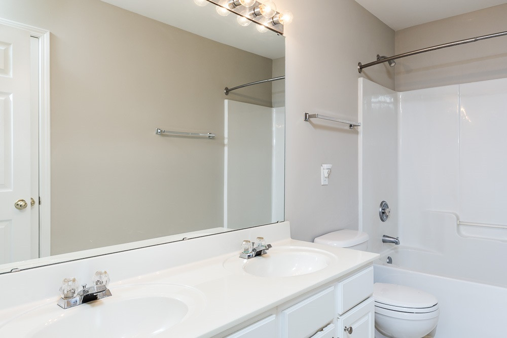 5419 Regatta Way Raleigh, NC 27613 - Photo 21 of 27 a bathroom with a sink and a mirror