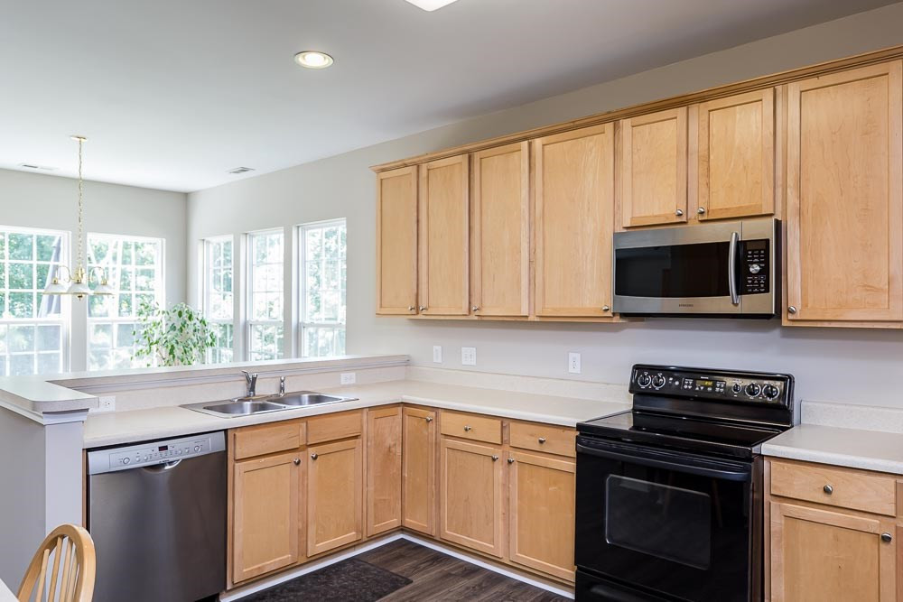 5419 Regatta Way Raleigh, NC 27613 - Photo 6 of 27 a kitchen with stainless steel appliances a stove sink and microwave