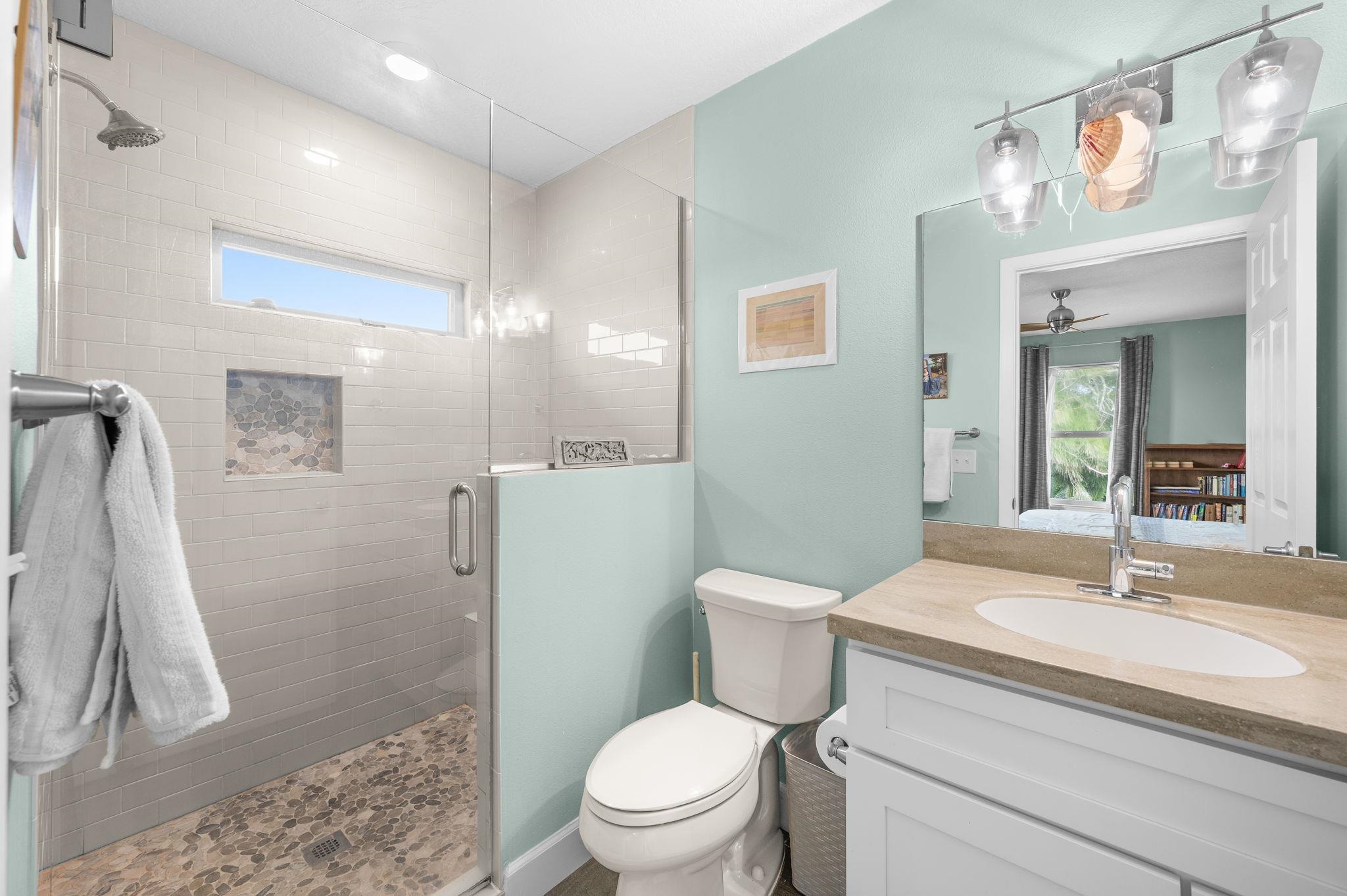 8950 Gene Johnson Road St. Augustine, FL 32080 - Photo 14 of 31 a bathroom with a sink a toilet a mirror and shower