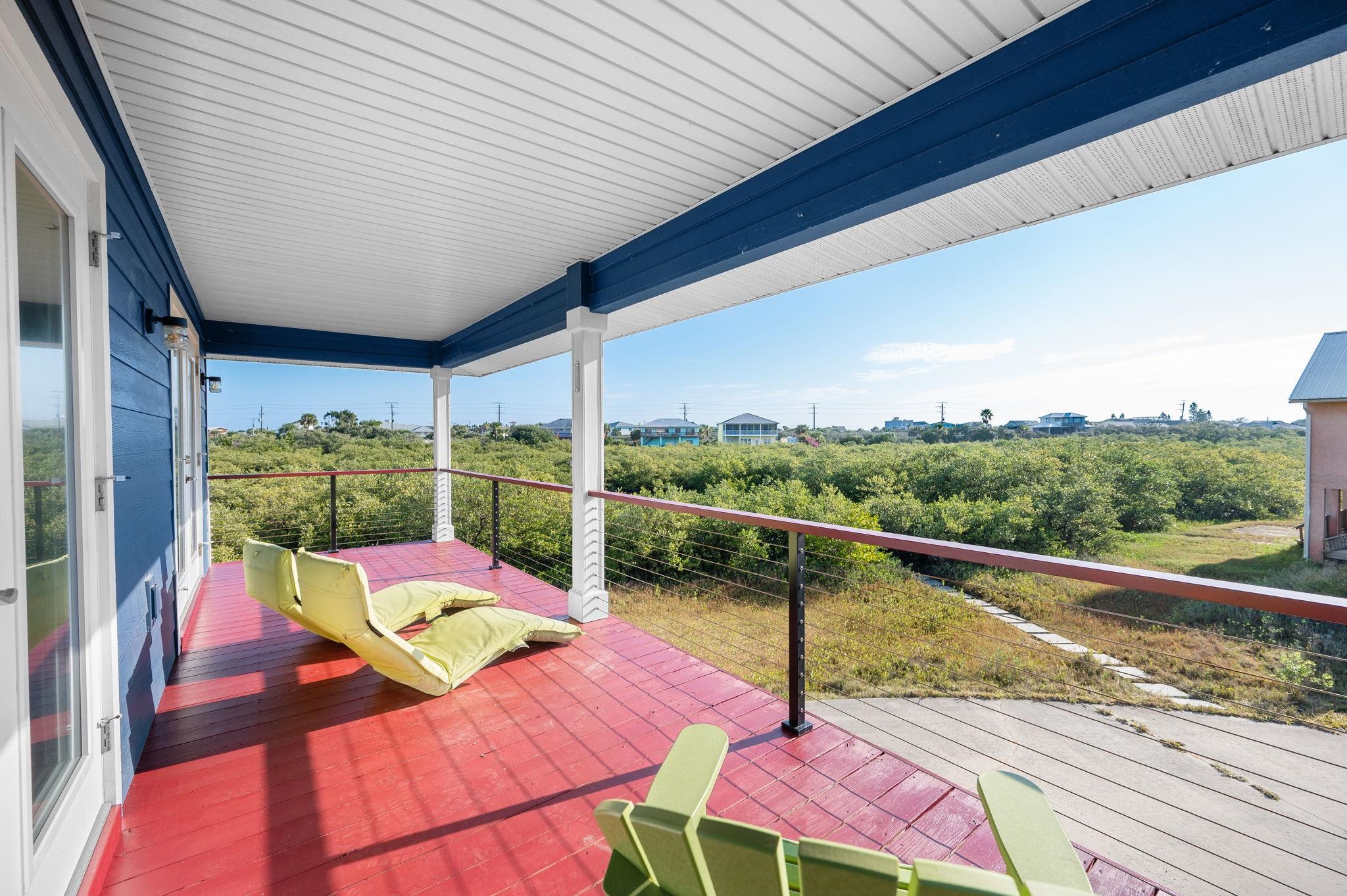 8950 Gene Johnson Road St. Augustine, FL 32080 - Photo 3 of 31 a view of a balcony with chair and wooden floor