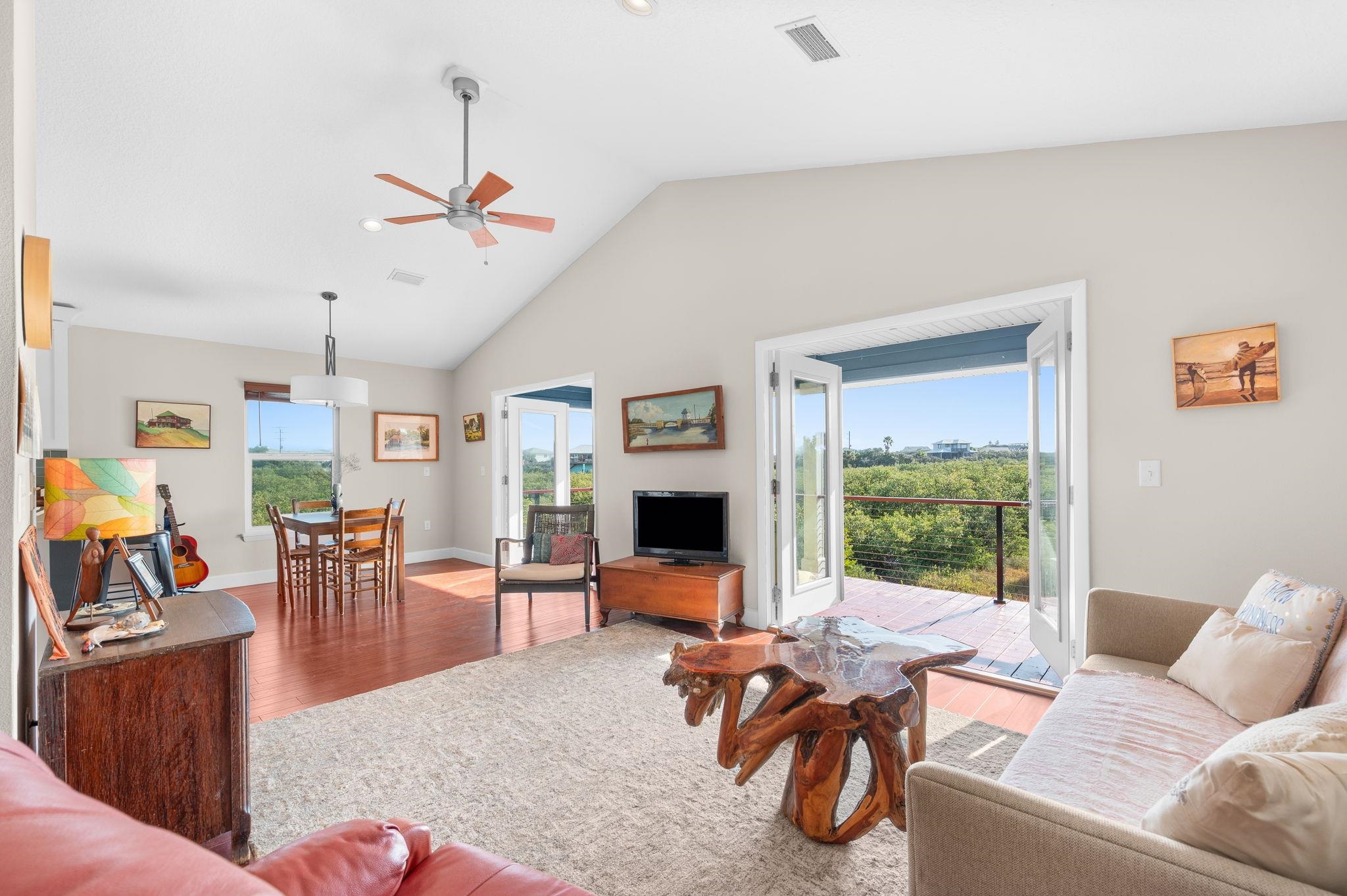 8950 Gene Johnson Road St. Augustine, FL 32080 - Photo 6 of 31 a living room with furniture floor to ceiling window and a flat screen tv