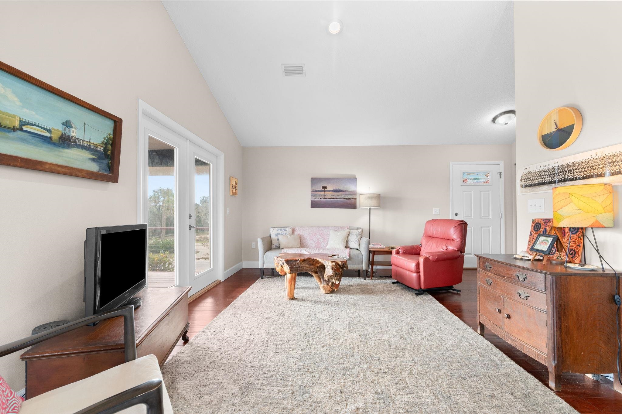 8950 Gene Johnson Road St. Augustine, FL 32080 - Photo 8 of 31 a living room with furniture a flat screen tv and a fireplace