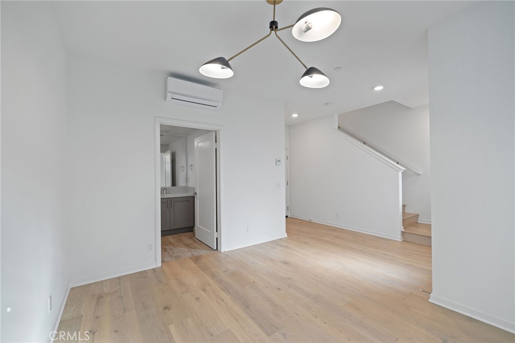 712 South Grable Circle Orange, CA 92868 - Photo 11 of 42 an empty room with wooden floor and windows