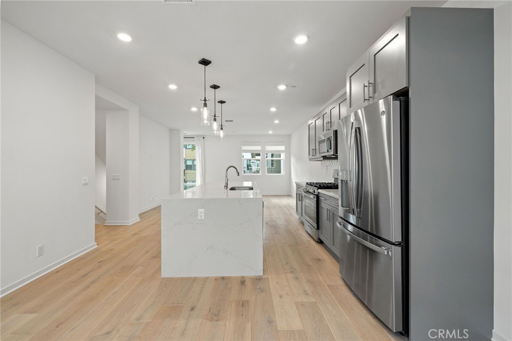 712 South Grable Circle Orange, CA 92868 - Photo 16 of 42 a kitchen with stainless steel appliances a refrigerator and a wooden floor