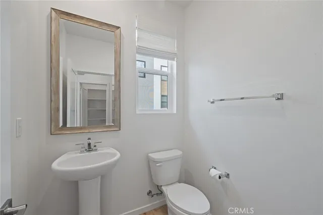 a bathroom with a sink a toilet and mirror