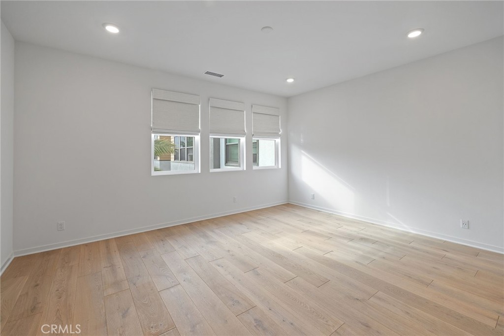 712 South Grable Circle Orange, CA 92868 - Photo 27 of 42 an empty room with wooden floor and windows