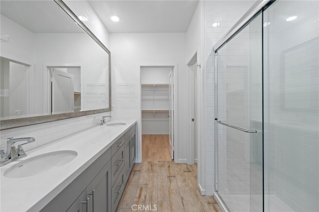 712 South Grable Circle Orange, CA 92868 - Photo 30 of 42 a bathroom with a double vanity sink a mirror and a shower